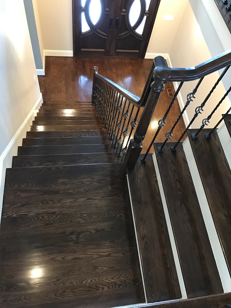 Dark walnut stairs with curved railing
